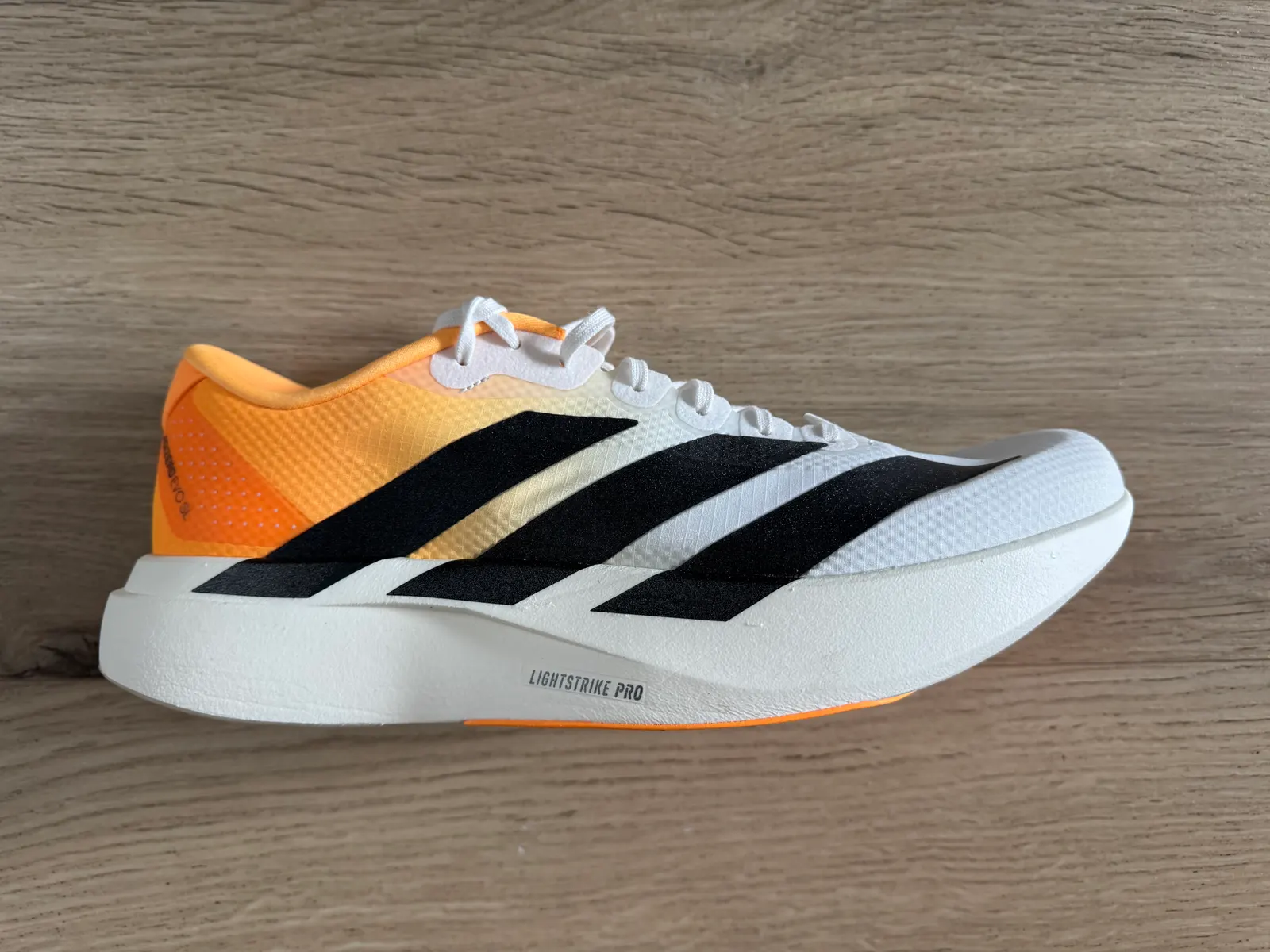 Side view of the Adidas Adizero EVO SL Woven with its full-length Lightstrike Pro midsole